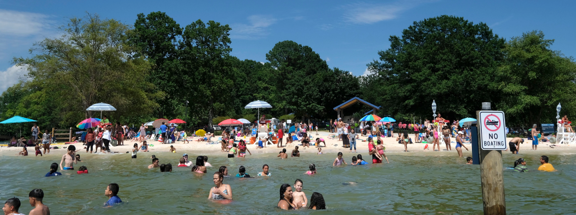 Familes enjoying summer at Ramsey Creek Beach in Cornelius.