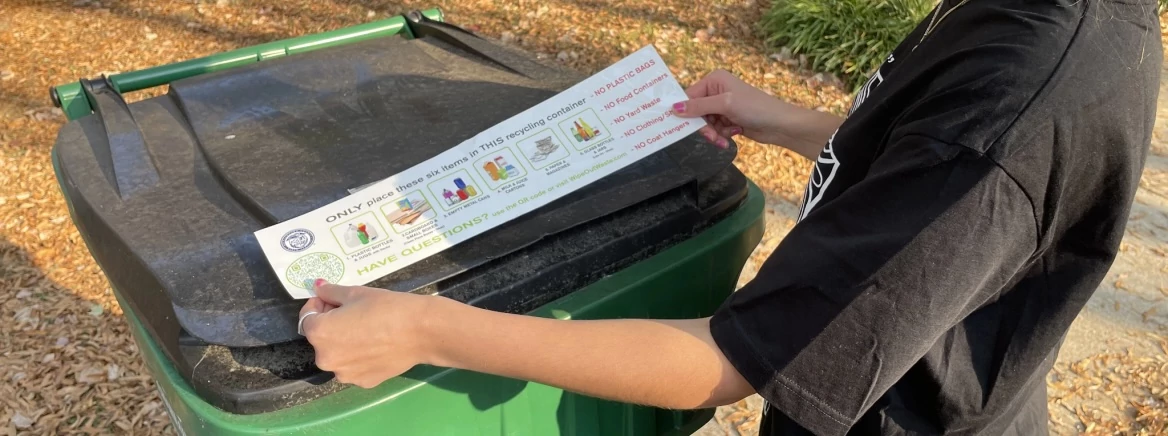 Recycling right sticker A person holding a sticker showing the rights ways to recycle.